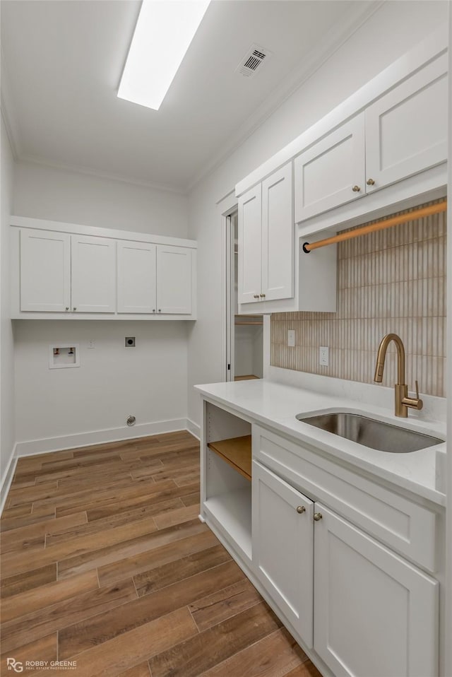 kitchen featuring white cabinetry, sink, dark wood-type flooring, and ornamental molding