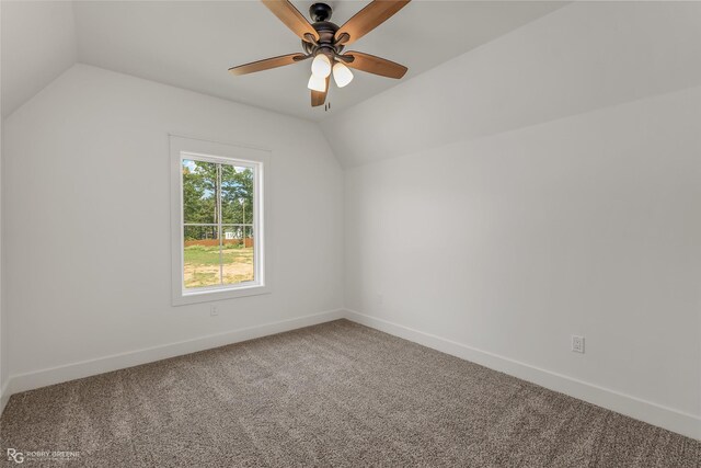 unfurnished room with light carpet, vaulted ceiling, and ceiling fan