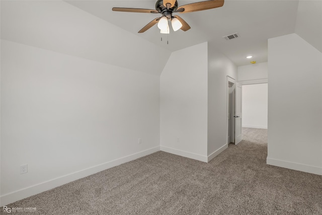 bonus room with vaulted ceiling, light colored carpet, and ceiling fan