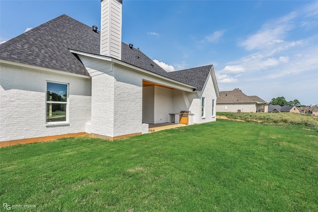 rear view of house featuring a lawn