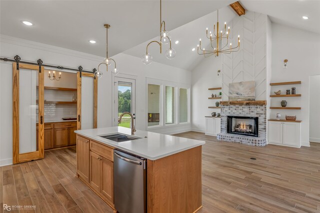 kitchen featuring dark wood-type flooring, a barn door, backsplash, pendant lighting, and a notable chandelier