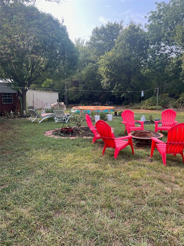 view of yard with a fire pit