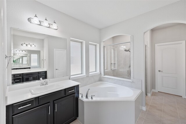 bathroom featuring tile patterned floors, vanity, and separate shower and tub