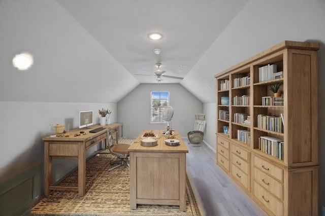 office space featuring ceiling fan, vaulted ceiling, and light wood-type flooring