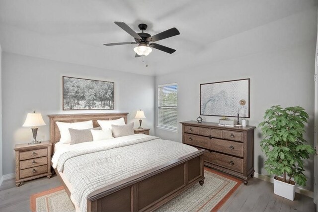 bedroom with ceiling fan and light hardwood / wood-style flooring