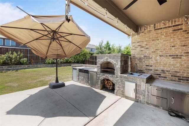 view of patio / terrace featuring area for grilling and sink