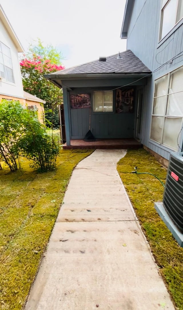 exterior space featuring central AC and a yard