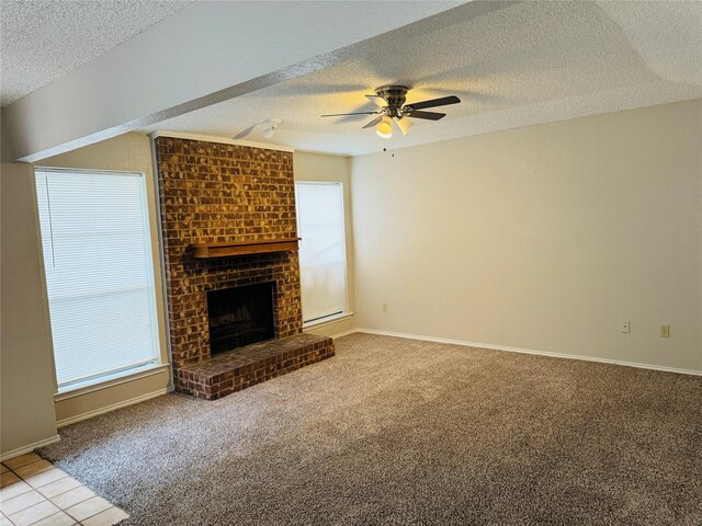 unfurnished living room featuring carpet flooring, a fireplace, a textured ceiling, and ceiling fan