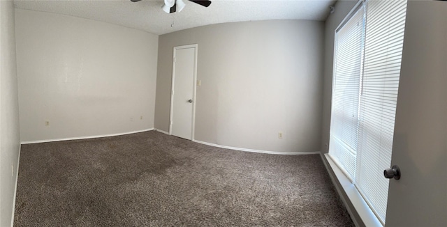 empty room with ceiling fan, carpet flooring, and a textured ceiling