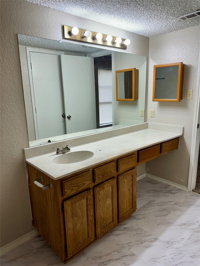 bathroom with vanity and a textured ceiling