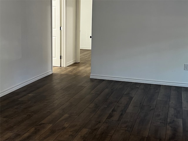 empty room with dark hardwood / wood-style flooring