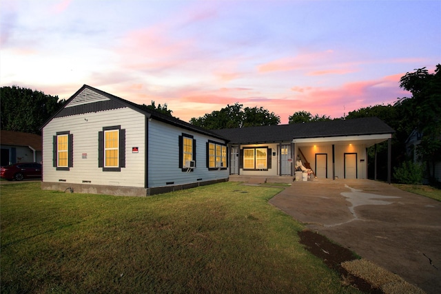 view of front of home with crawl space, a lawn, concrete driveway, and a carport