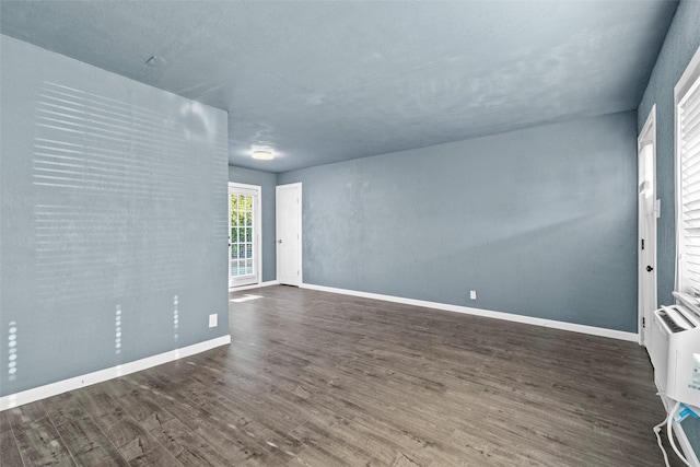 unfurnished room with hardwood / wood-style flooring