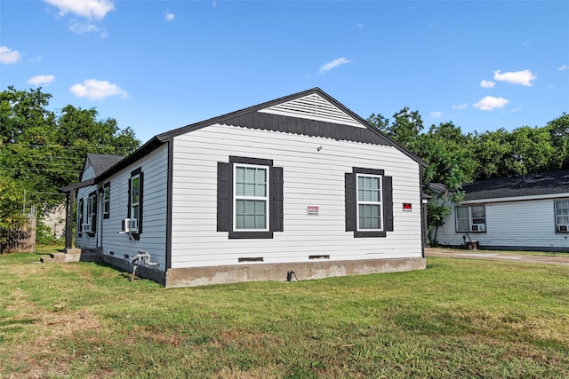 view of front of property with cooling unit and a front yard