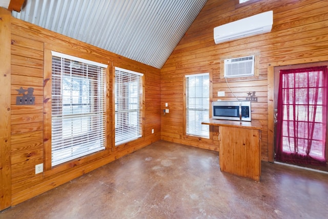 kitchen featuring wood walls, a wall mounted AC, wood counters, and high vaulted ceiling