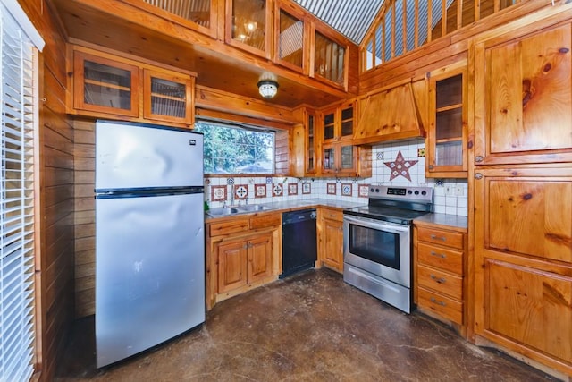 kitchen featuring tasteful backsplash, sink, premium range hood, and appliances with stainless steel finishes