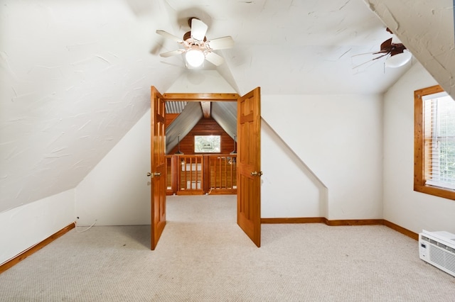 additional living space featuring lofted ceiling, light colored carpet, and ceiling fan