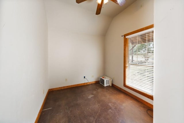 spare room with vaulted ceiling, a wall unit AC, and ceiling fan