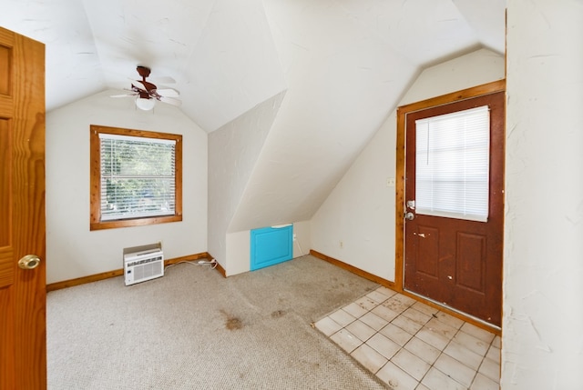 additional living space with lofted ceiling, light colored carpet, and ceiling fan