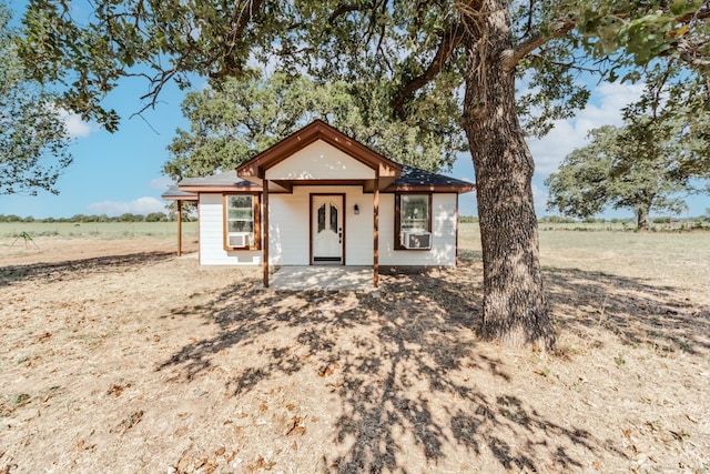 view of front of house with cooling unit and a rural view