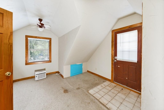 additional living space featuring light carpet and vaulted ceiling