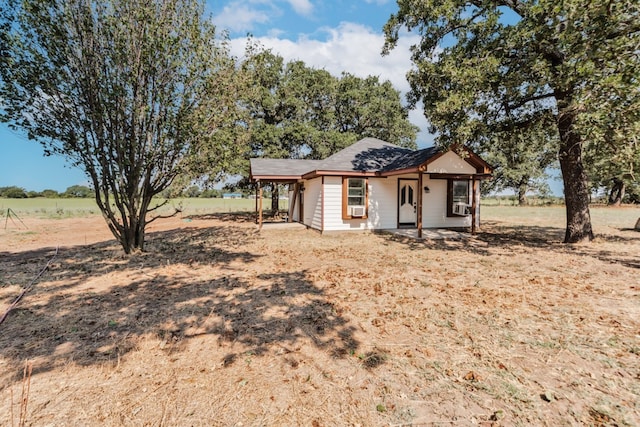 view of front of property with a rural view and cooling unit