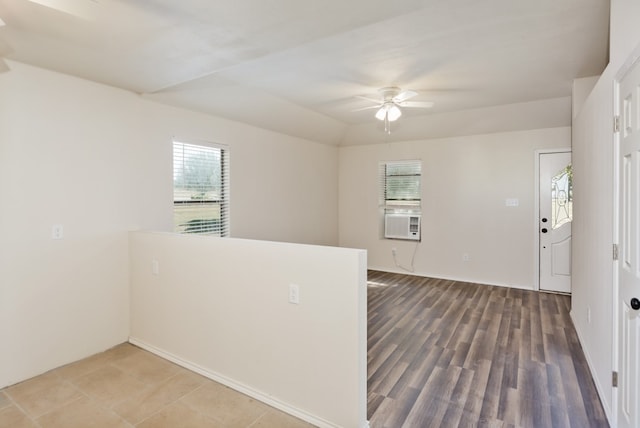 unfurnished room with cooling unit, a wealth of natural light, wood-type flooring, and ceiling fan