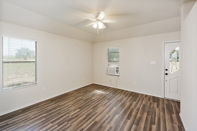 spare room featuring dark wood-type flooring, ceiling fan, and a healthy amount of sunlight