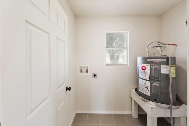 laundry area with hookup for a washing machine, electric water heater, hookup for an electric dryer, and light tile patterned floors