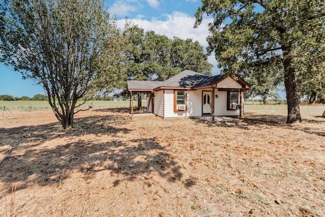 view of front of property with a rural view and cooling unit