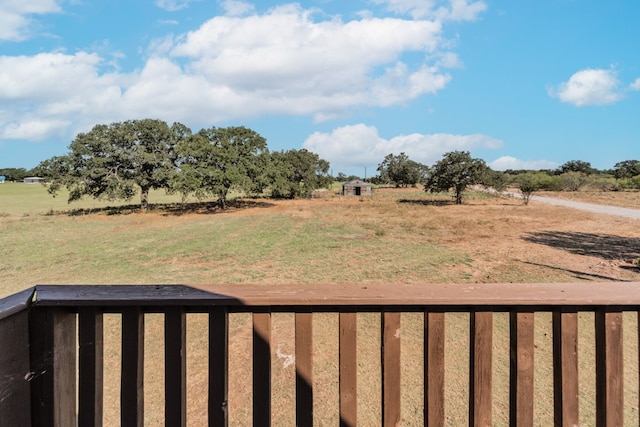 view of yard featuring a rural view and a balcony