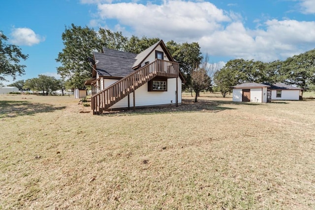 exterior space featuring a lawn, a deck, and a shed