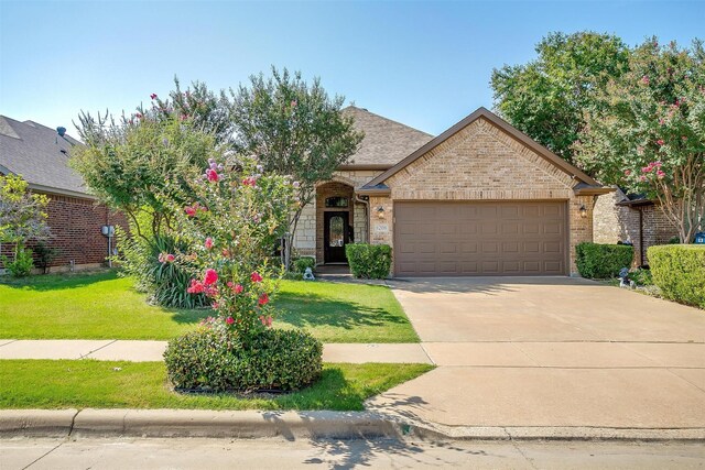 view of front of home with a garage and a front yard