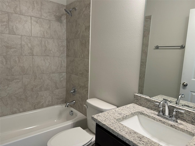 full bathroom with tiled shower / bath combo, vanity, and toilet