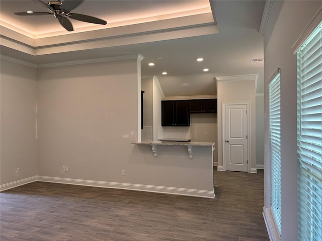 unfurnished living room featuring crown molding, dark hardwood / wood-style floors, and ceiling fan