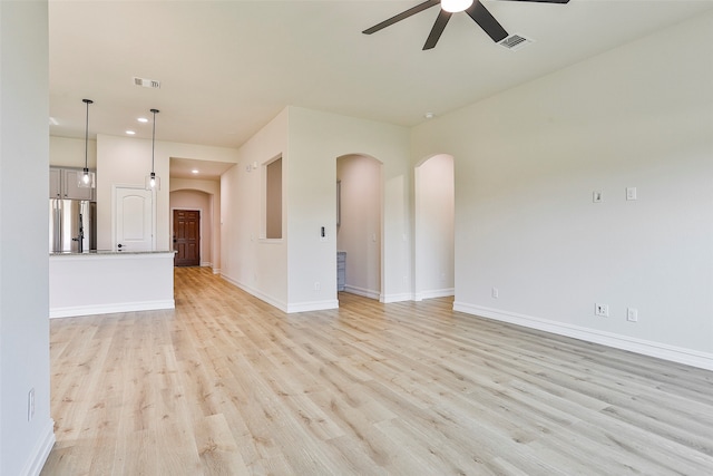 unfurnished living room with ceiling fan and light hardwood / wood-style flooring