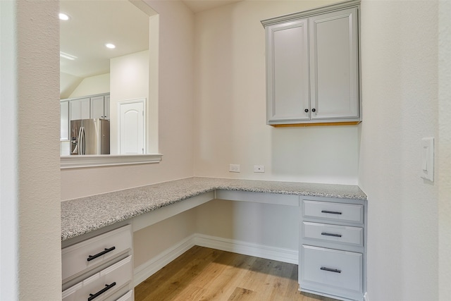 unfurnished office with light wood-type flooring