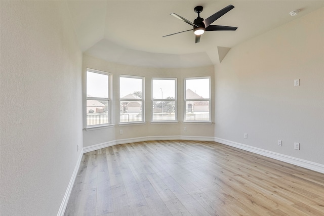 spare room featuring ceiling fan, light hardwood / wood-style flooring, and lofted ceiling