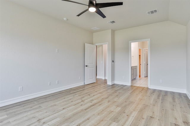 unfurnished bedroom with ceiling fan, ensuite bathroom, vaulted ceiling, and light hardwood / wood-style floors