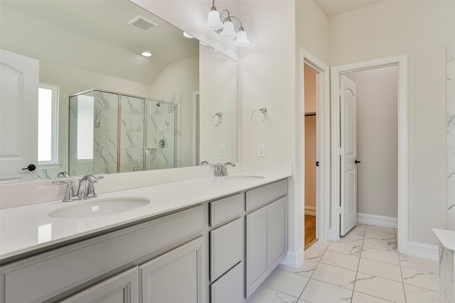 bathroom featuring lofted ceiling, double vanity, walk in shower, and tile patterned flooring