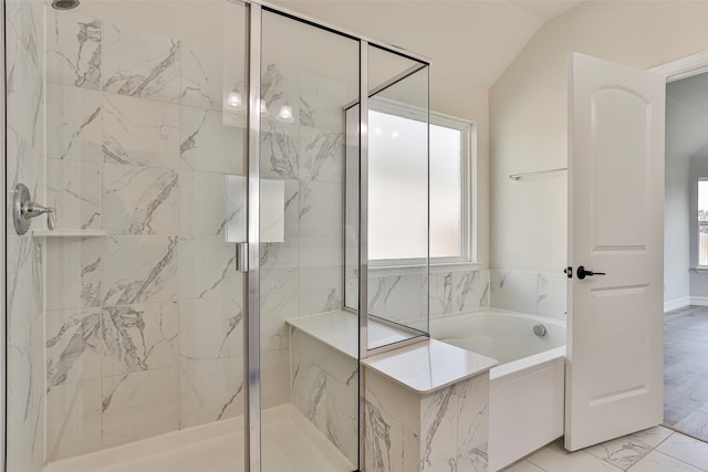 bathroom featuring vaulted ceiling, plus walk in shower, and tile patterned flooring