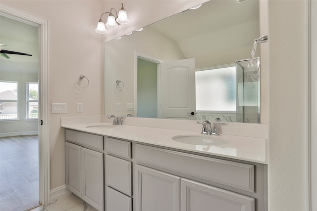 bathroom featuring ceiling fan, dual vanity, and hardwood / wood-style flooring