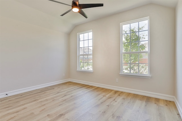 empty room with ceiling fan, light hardwood / wood-style flooring, a wealth of natural light, and lofted ceiling