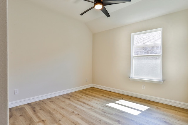 spare room with light hardwood / wood-style floors, lofted ceiling, ceiling fan, and a wealth of natural light