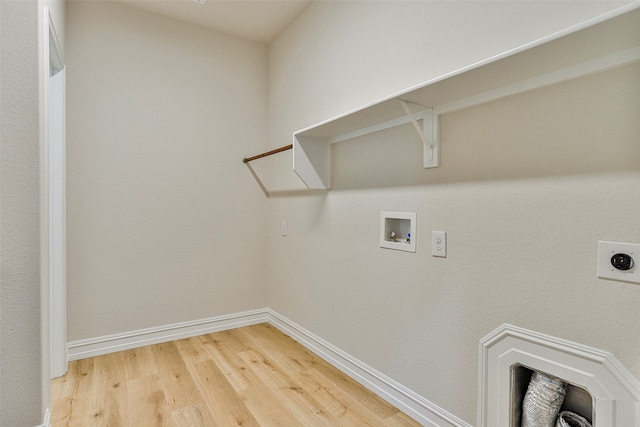 washroom featuring hookup for a washing machine, hardwood / wood-style flooring, and hookup for an electric dryer