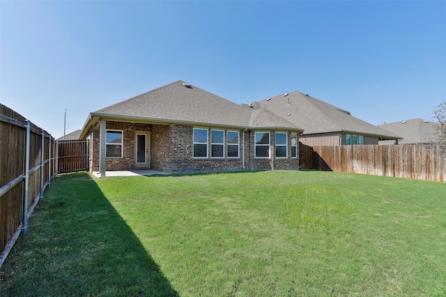 back of property featuring a patio area and a lawn