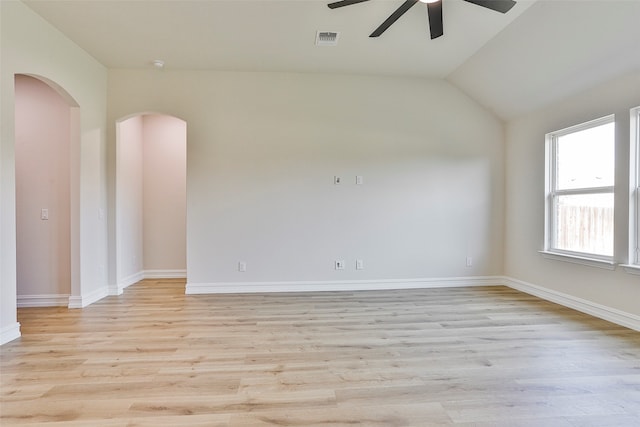 empty room featuring ceiling fan, lofted ceiling, and light hardwood / wood-style floors