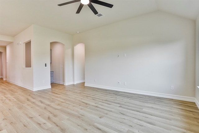 empty room with ceiling fan, light wood-type flooring, and vaulted ceiling