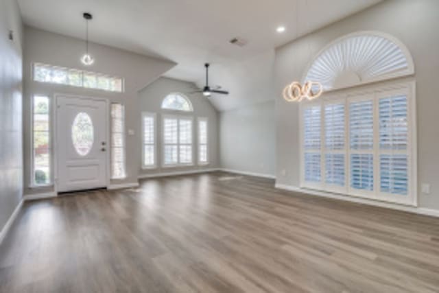 foyer entrance featuring ceiling fan, lofted ceiling, and hardwood / wood-style floors