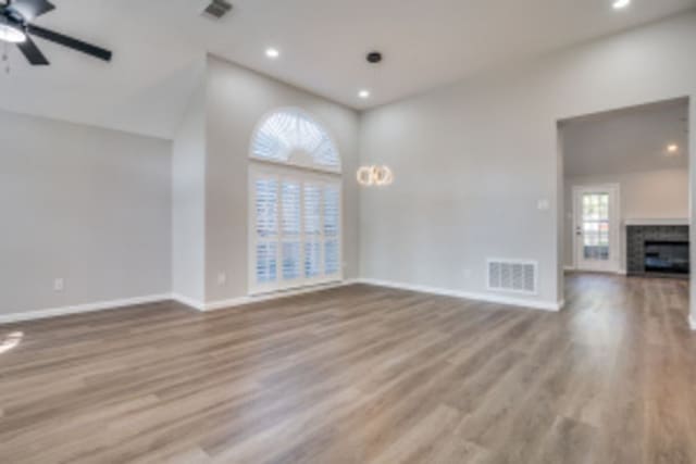 unfurnished living room with ceiling fan and wood-type flooring